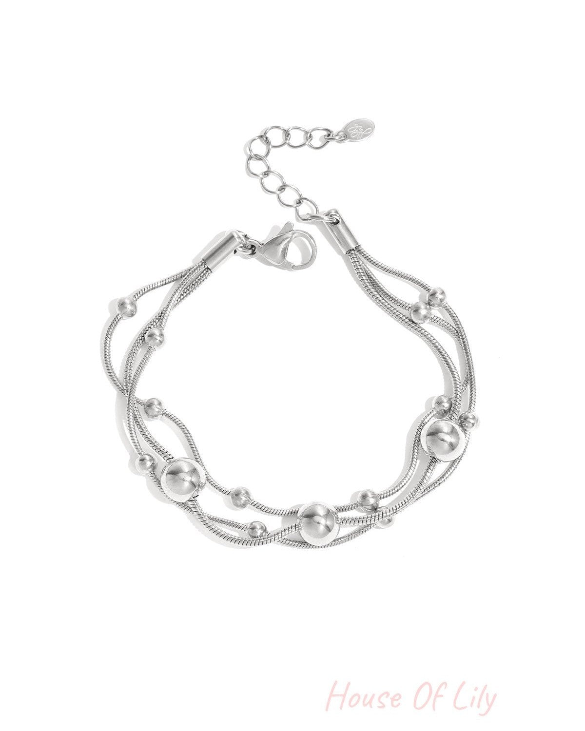 Silver multi-strand chain bracelet with polished round beads and adjustable lobster clasp on white background