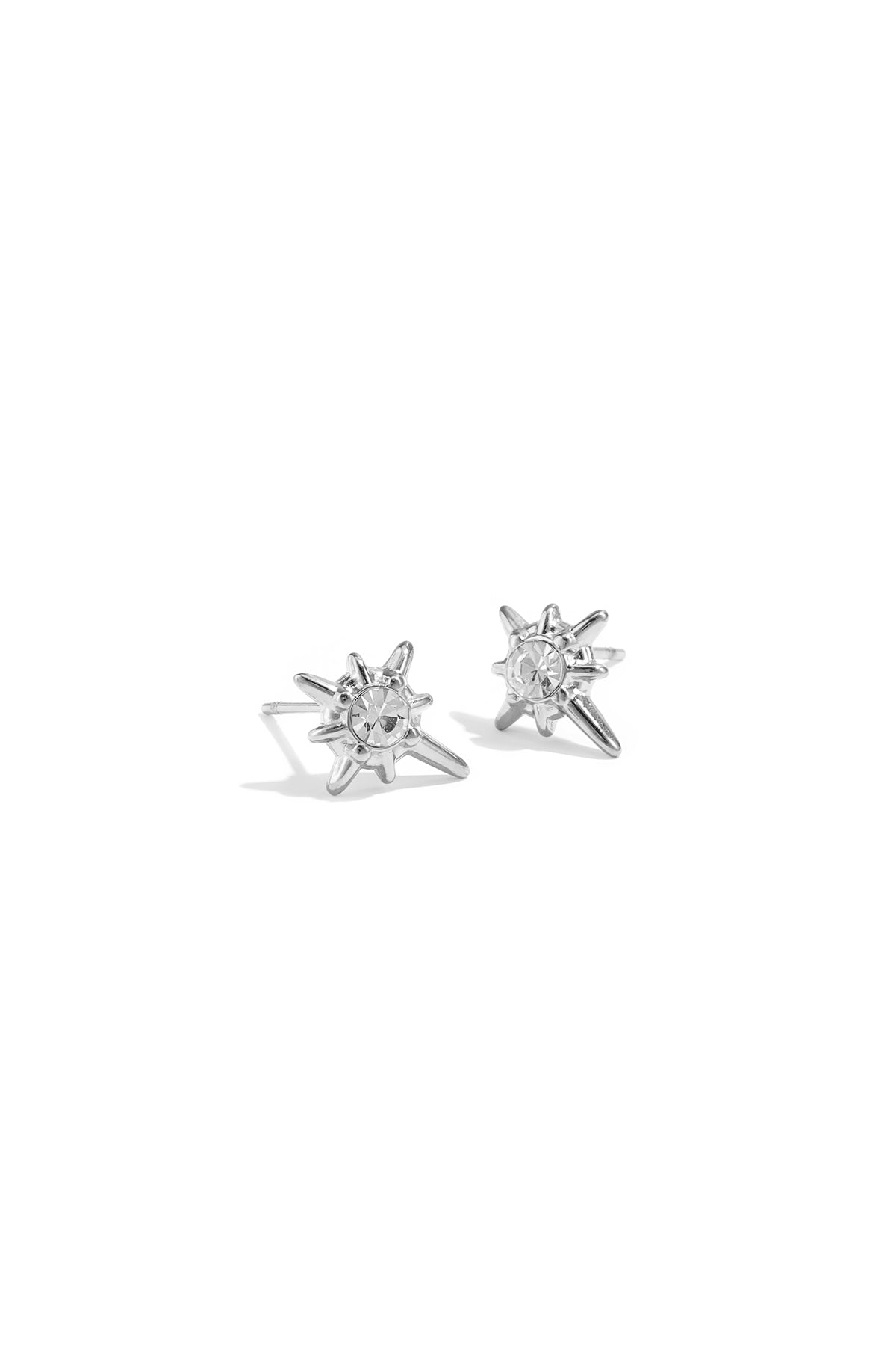 Pair of silver shooting star stud earrings with clear rhinestone center on white background