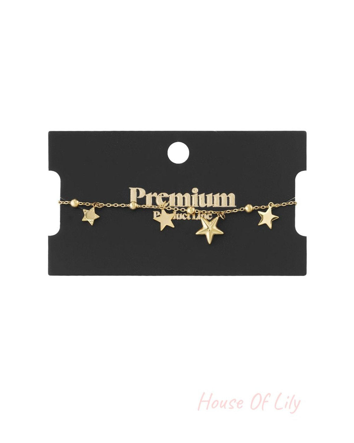 Gold-tone beaded charm bracelet featuring multiple dangling star pendants on a black display card.