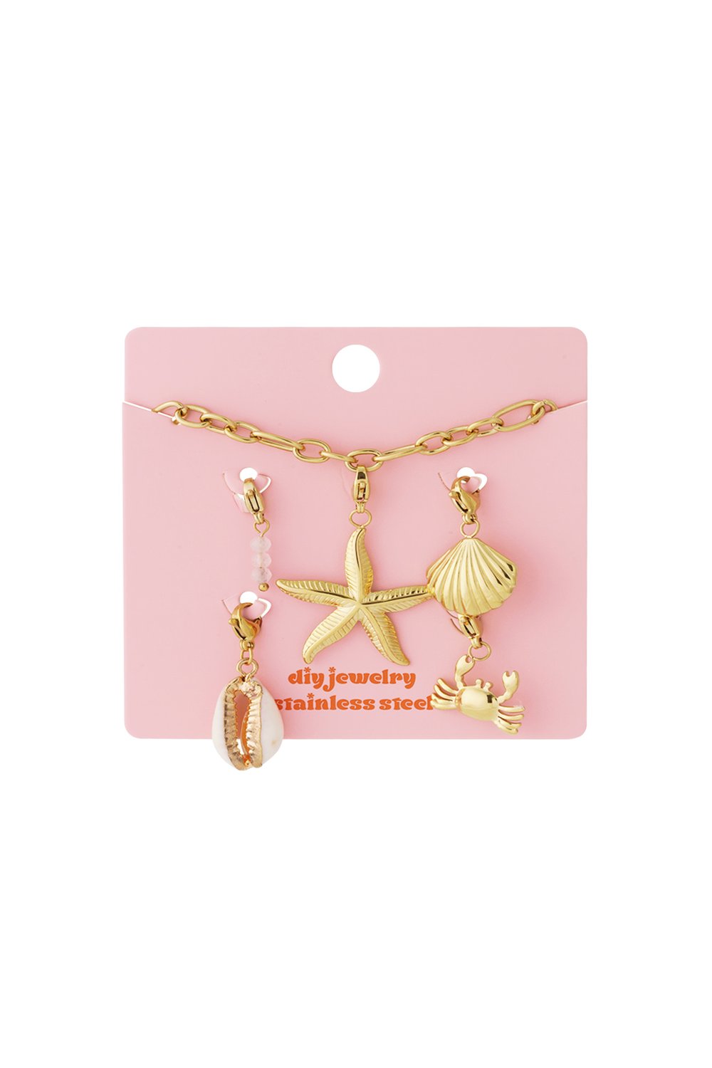 Gold chain bracelet with beach-themed charms including a starfish, seashell, and crab on a pink display card.