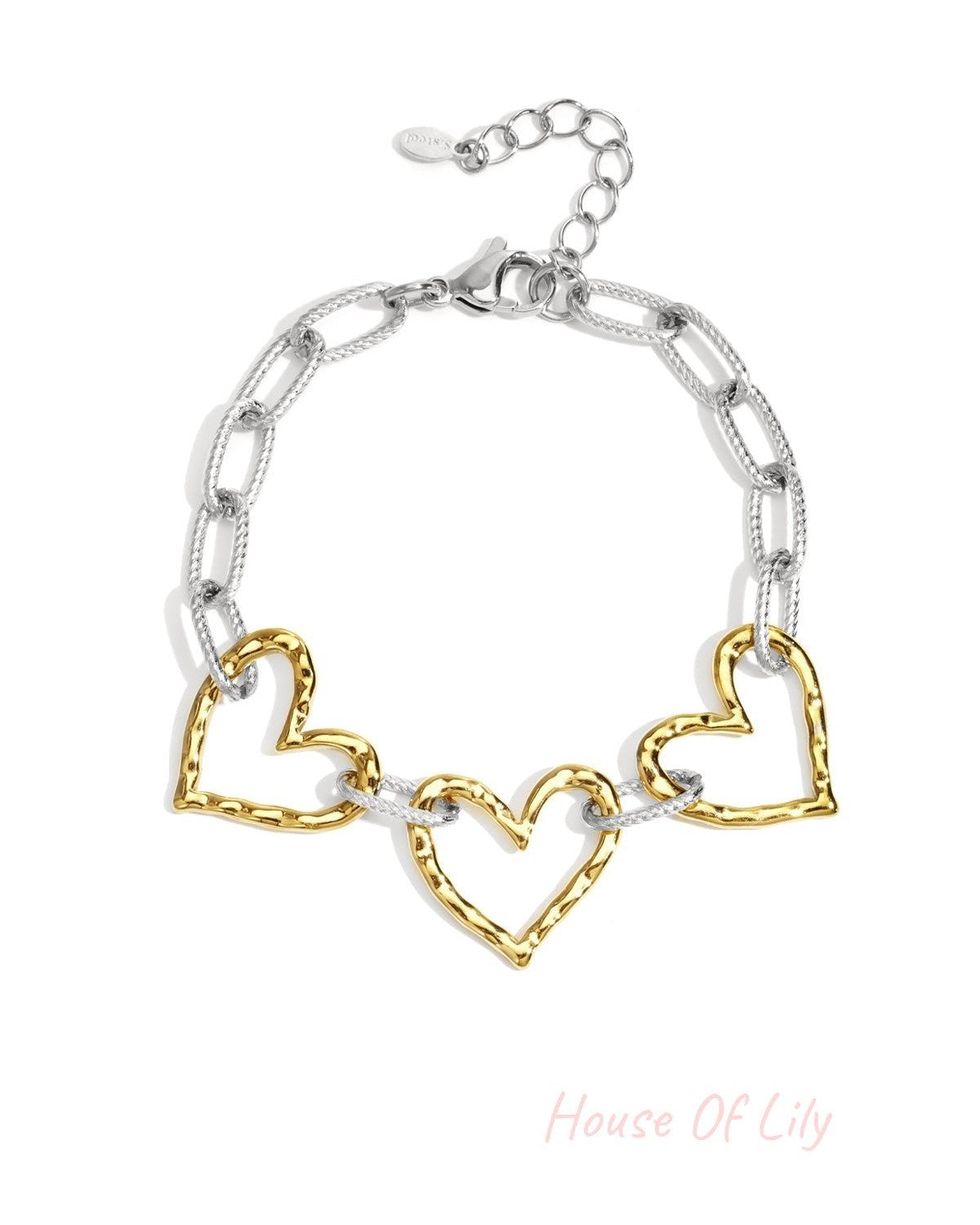 Two-tone bracelet with silver chain links and gold hammered heart charms displayed flat on white background