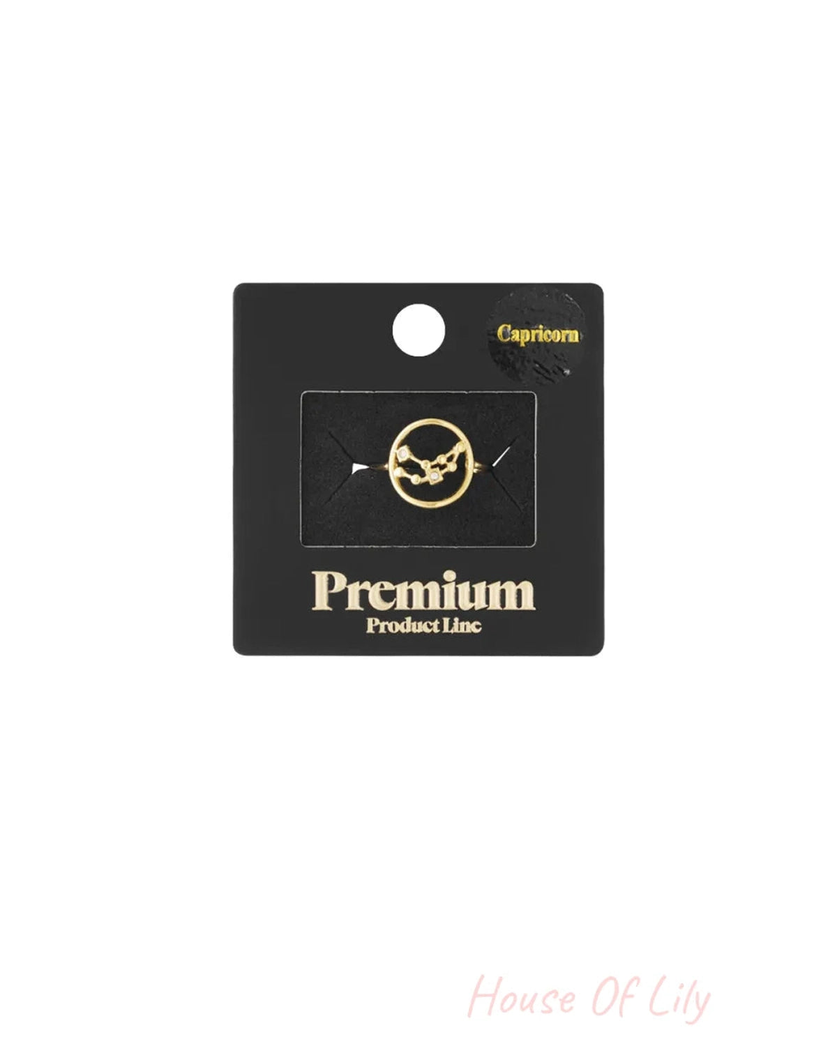Gold Capricorn constellation ring on black packaging.