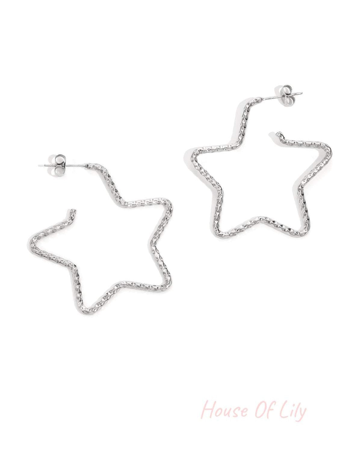 Silver star-shaped textured hoop earrings displayed on white background