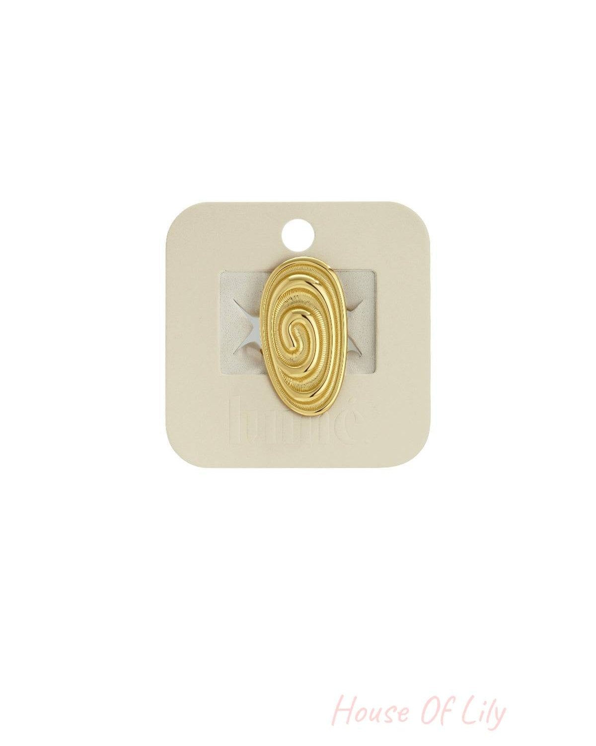 Gold-tone Wavy Gravy ring featuring an oval, textured spiral design mounted on a beige display card.