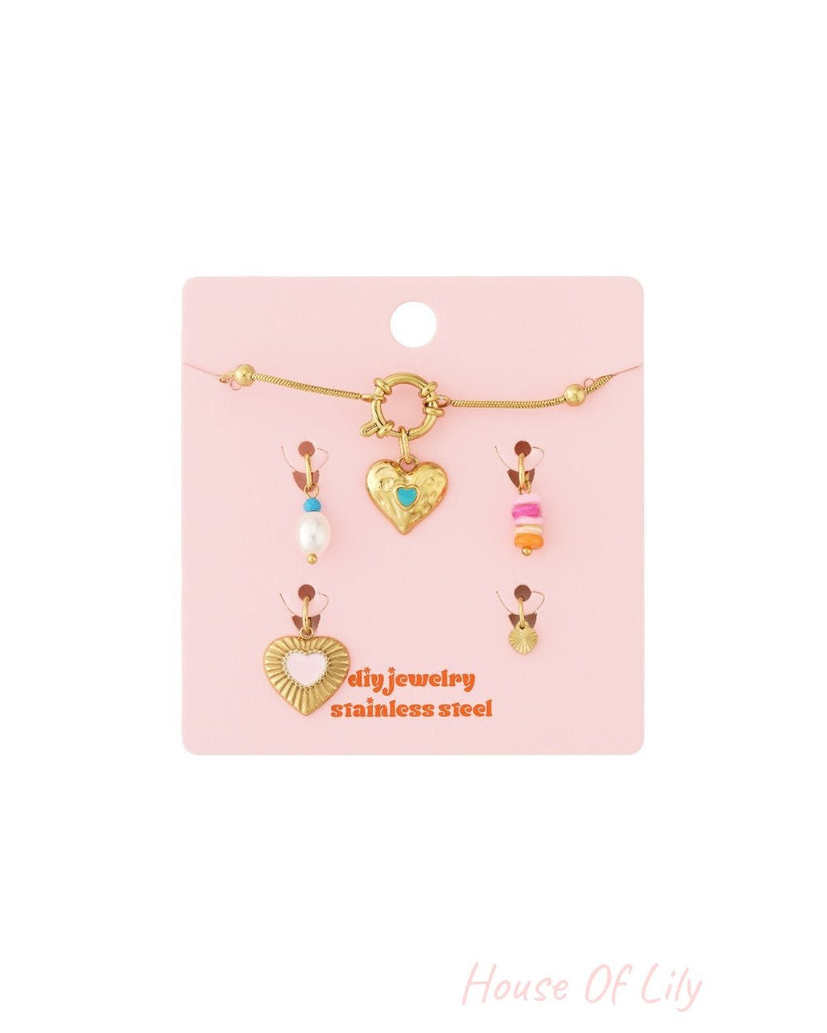 Elegant gold-tone stainless steel heart link bracelet set with colorful charms on a pink display card.