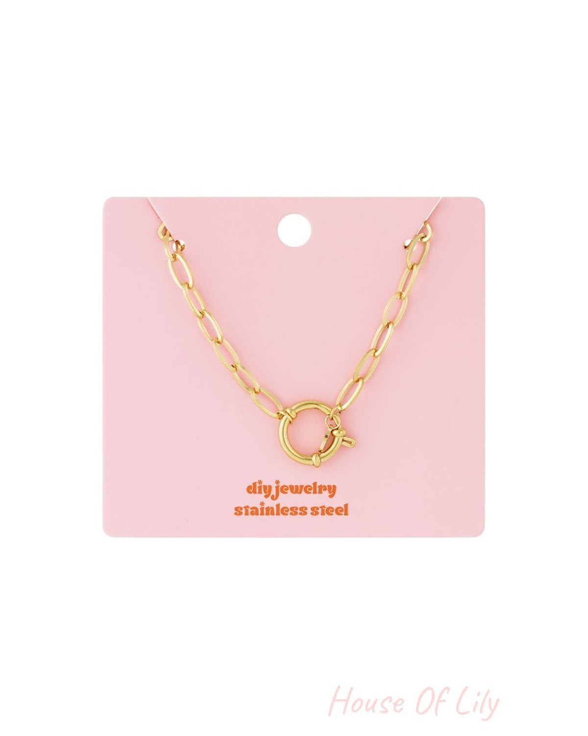 Polished Link Era gold stainless steel oval chain necklace with a circular toggle clasp on a pink display card.