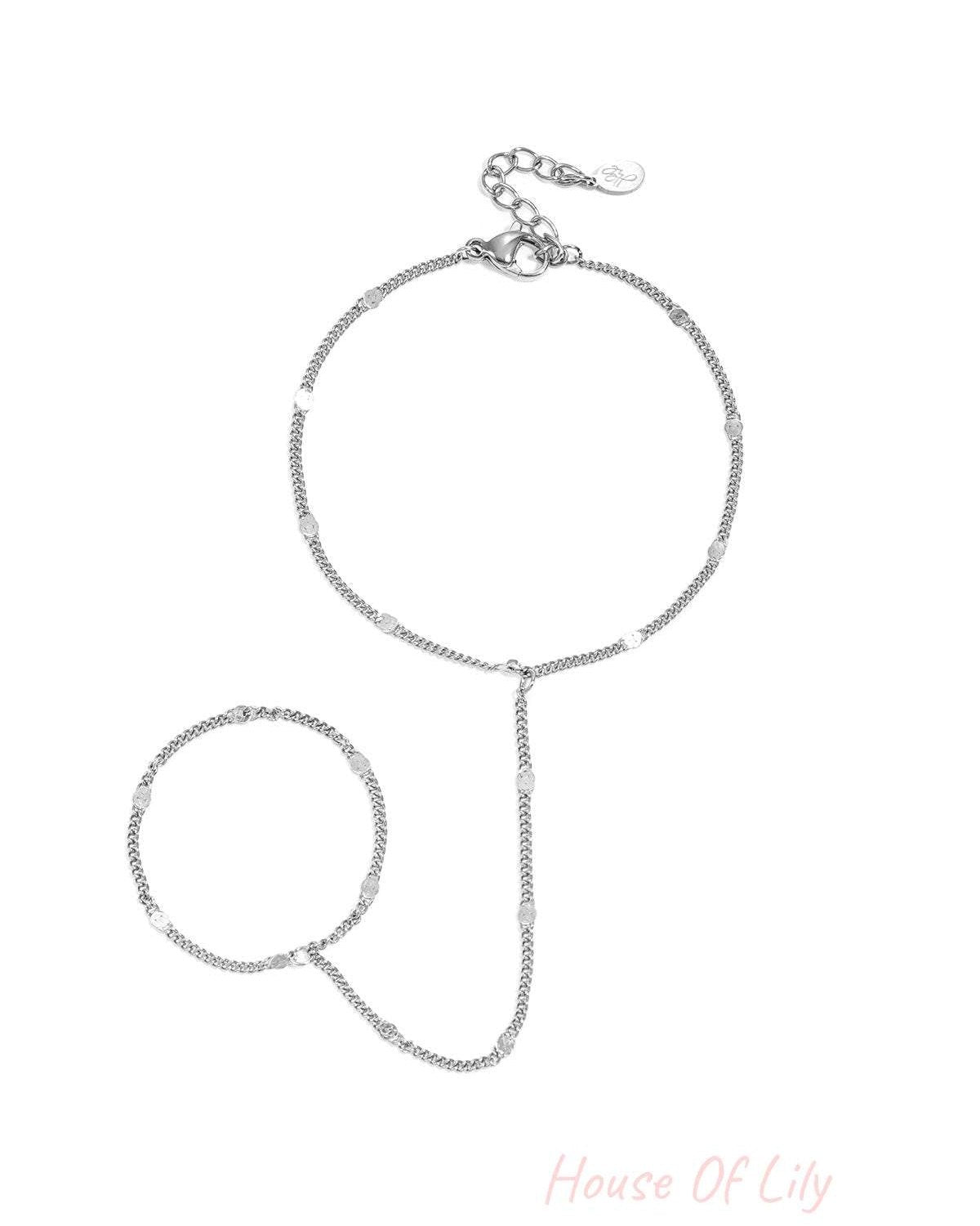 Delicate silver chain hand bracelet with small shimmering discs and adjustable lobster clasp