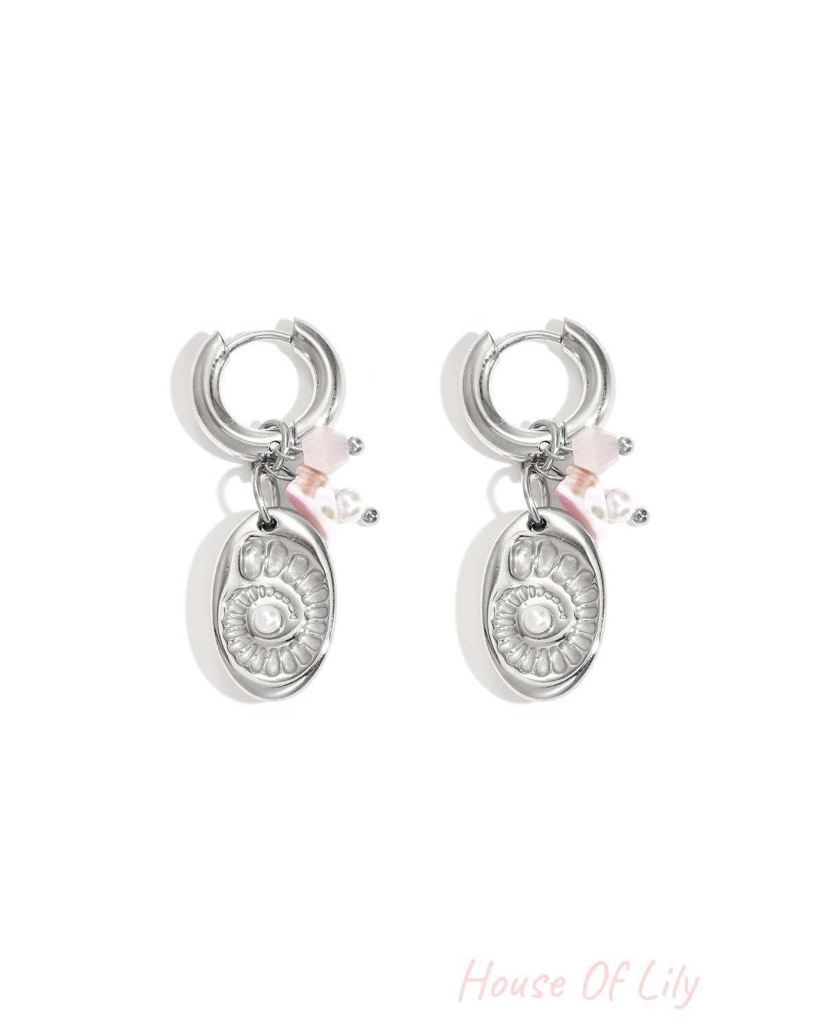 Pair of silver-tone drop earrings featuring a shell medallion charm and pink bead accents on white background