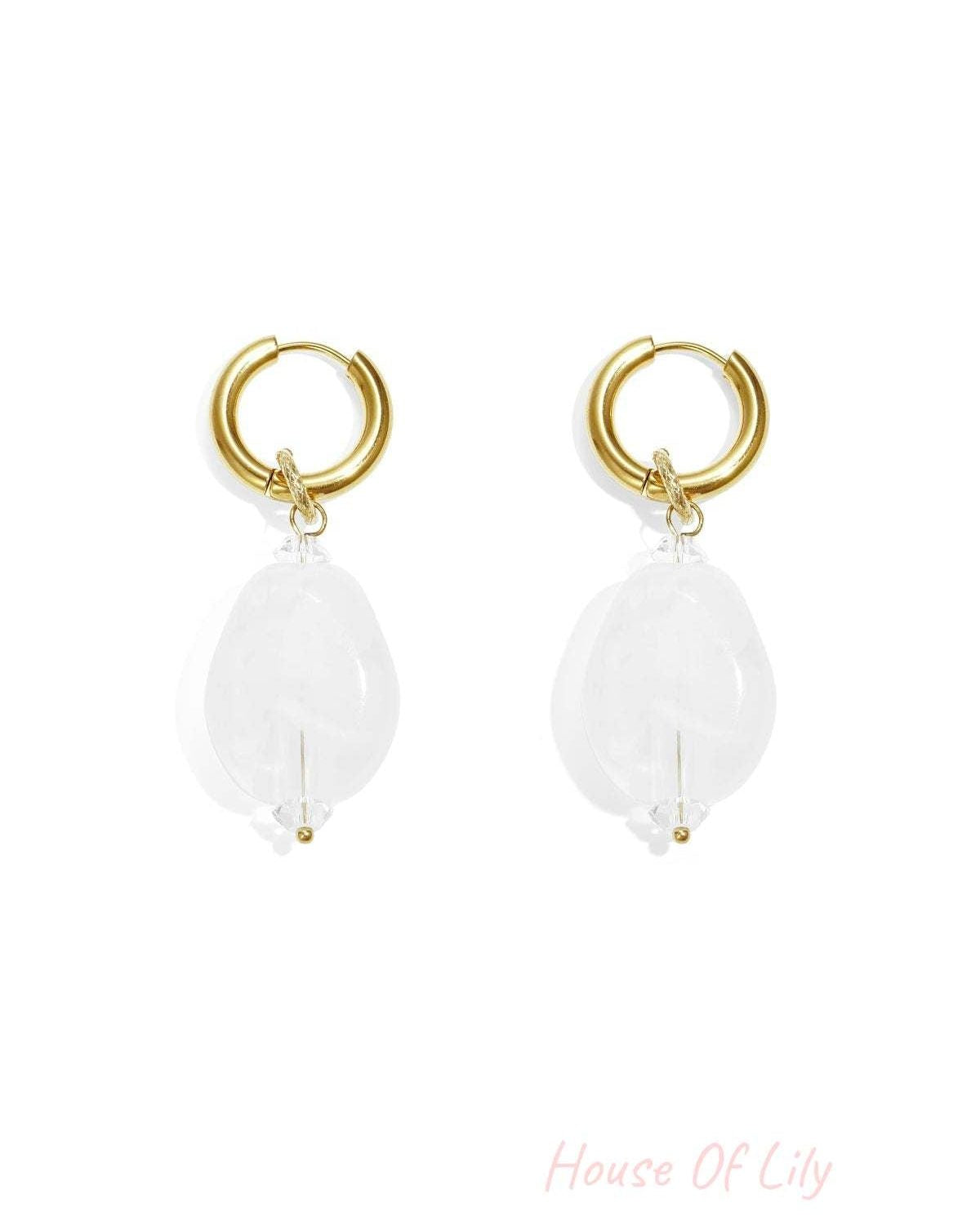 Gold hoop earrings with dangling, puffy, translucent white cloud-shaped pendants on a white background.