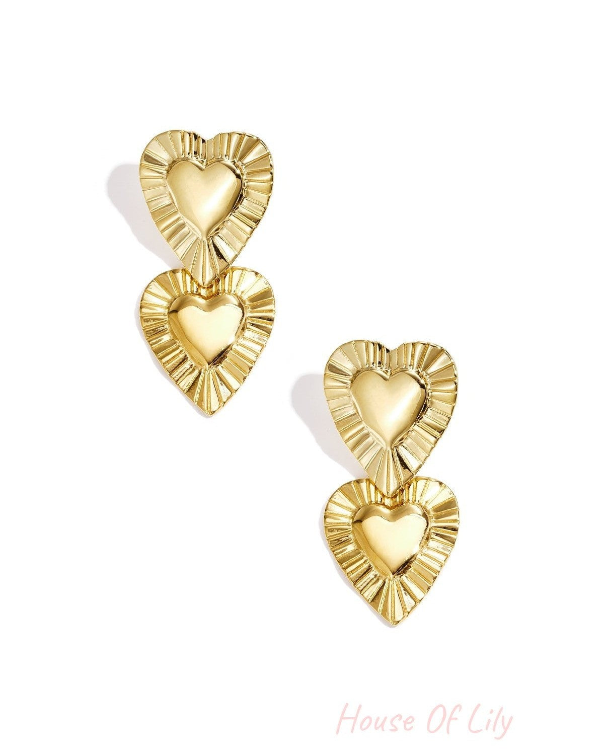 Golden drop earrings featuring two stacked heart shapes with textured, pleated borders and polished centers.