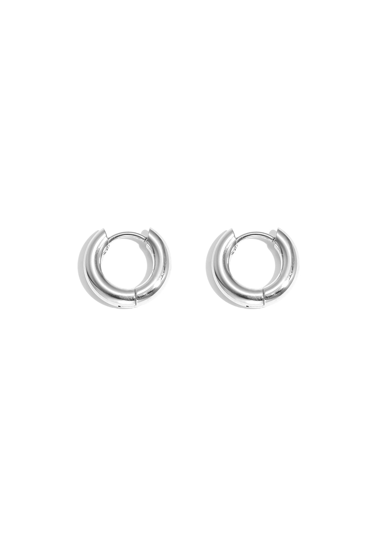 Pair of chunky silver hoop earrings with smooth polished finish on white background