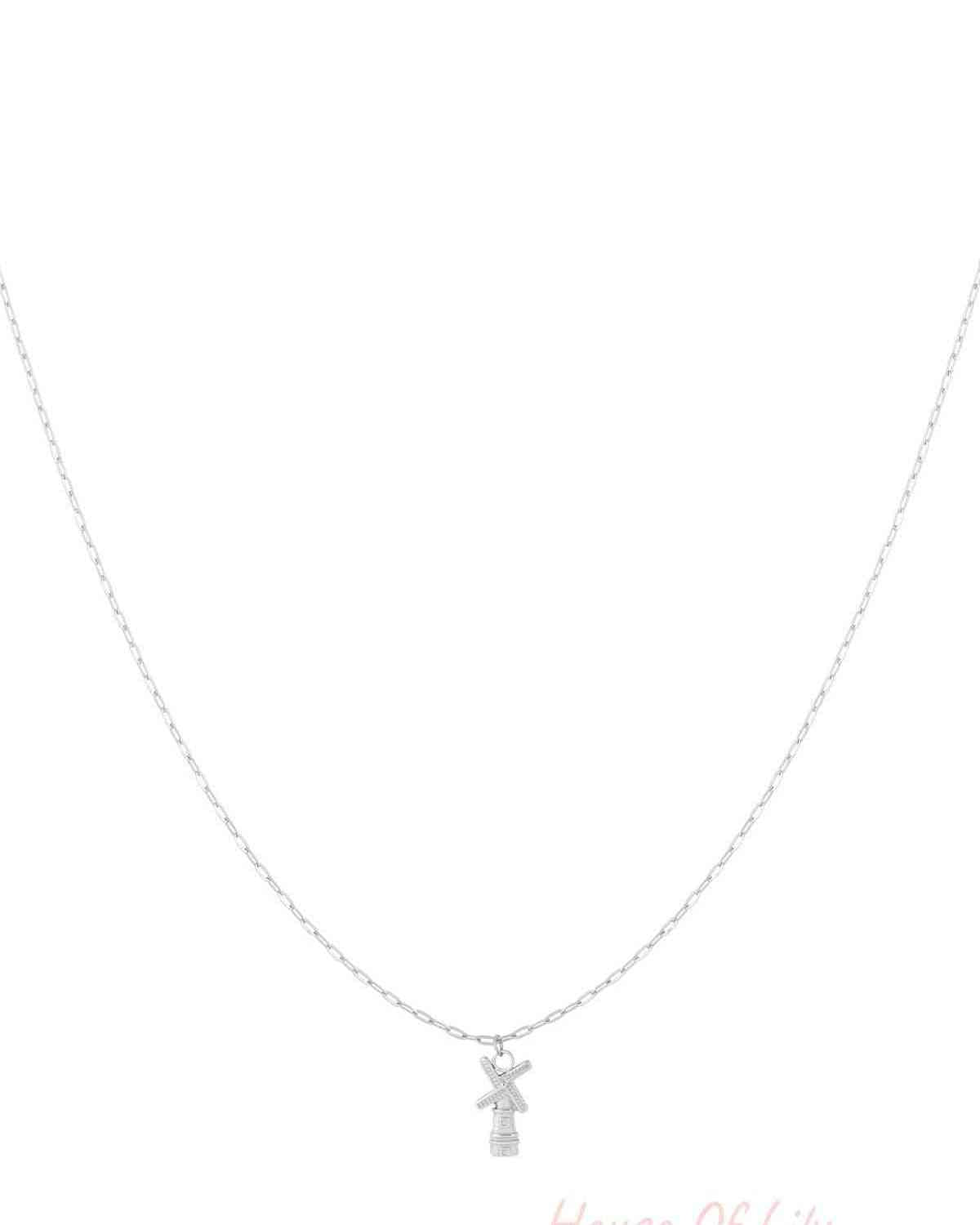 Silver chain necklace with a small windmill pendant displayed on white background