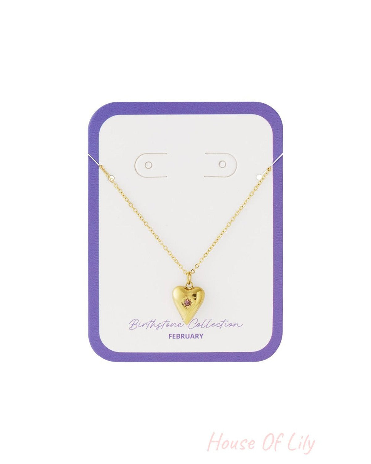 Gold necklace featuring a puffy heart pendant with a small pink February birthstone on a display card.