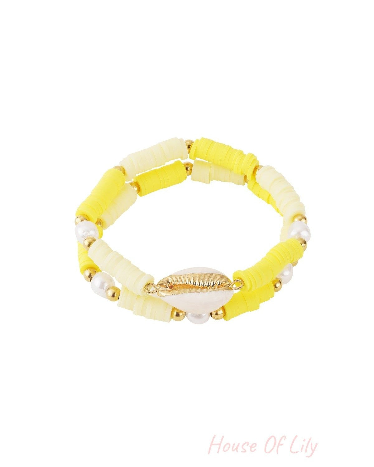 Yellow shell beaded bracelet set featuring layered polymer beads, pearls, and gold trim shell centerpiece on white background
