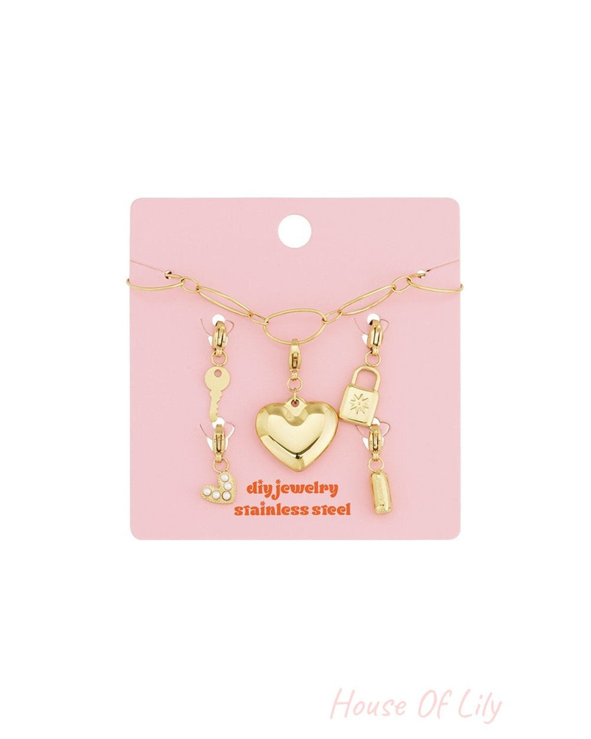Golden link charm bracelet kit on a pink card with heart, key, lock, and bar charms in gold stainless steel.