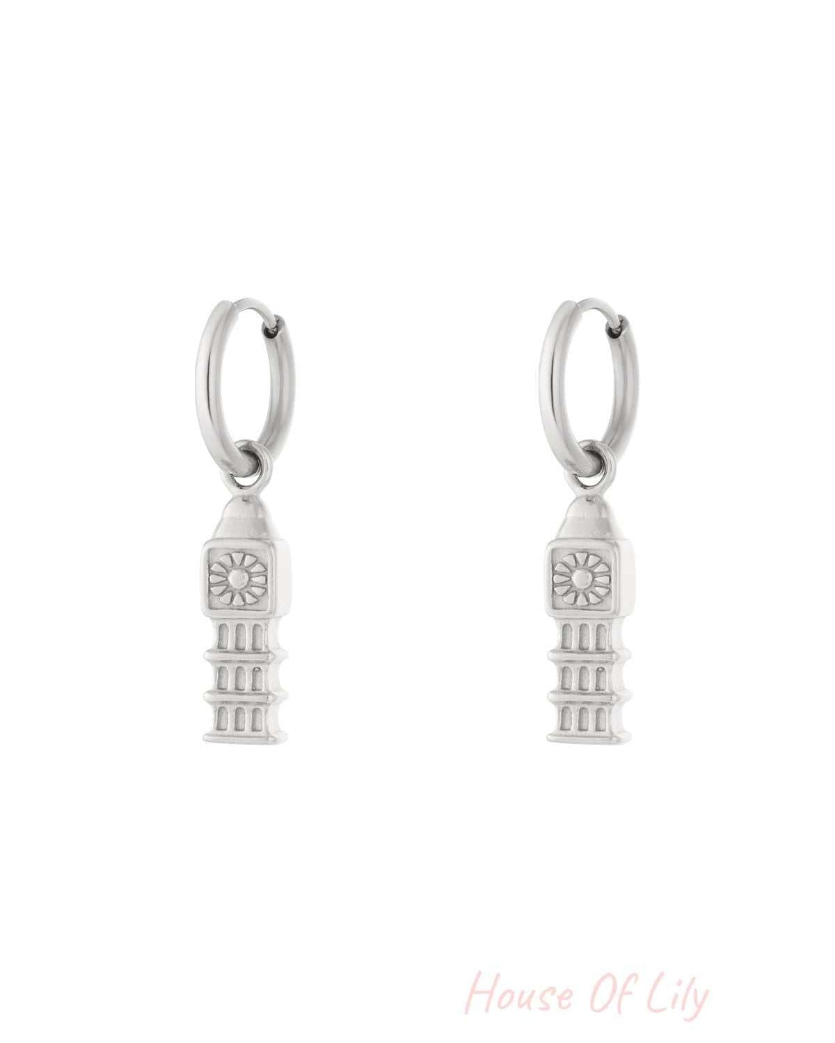 Pair of silver drop hoop earrings with detailed iconic tower charms hanging