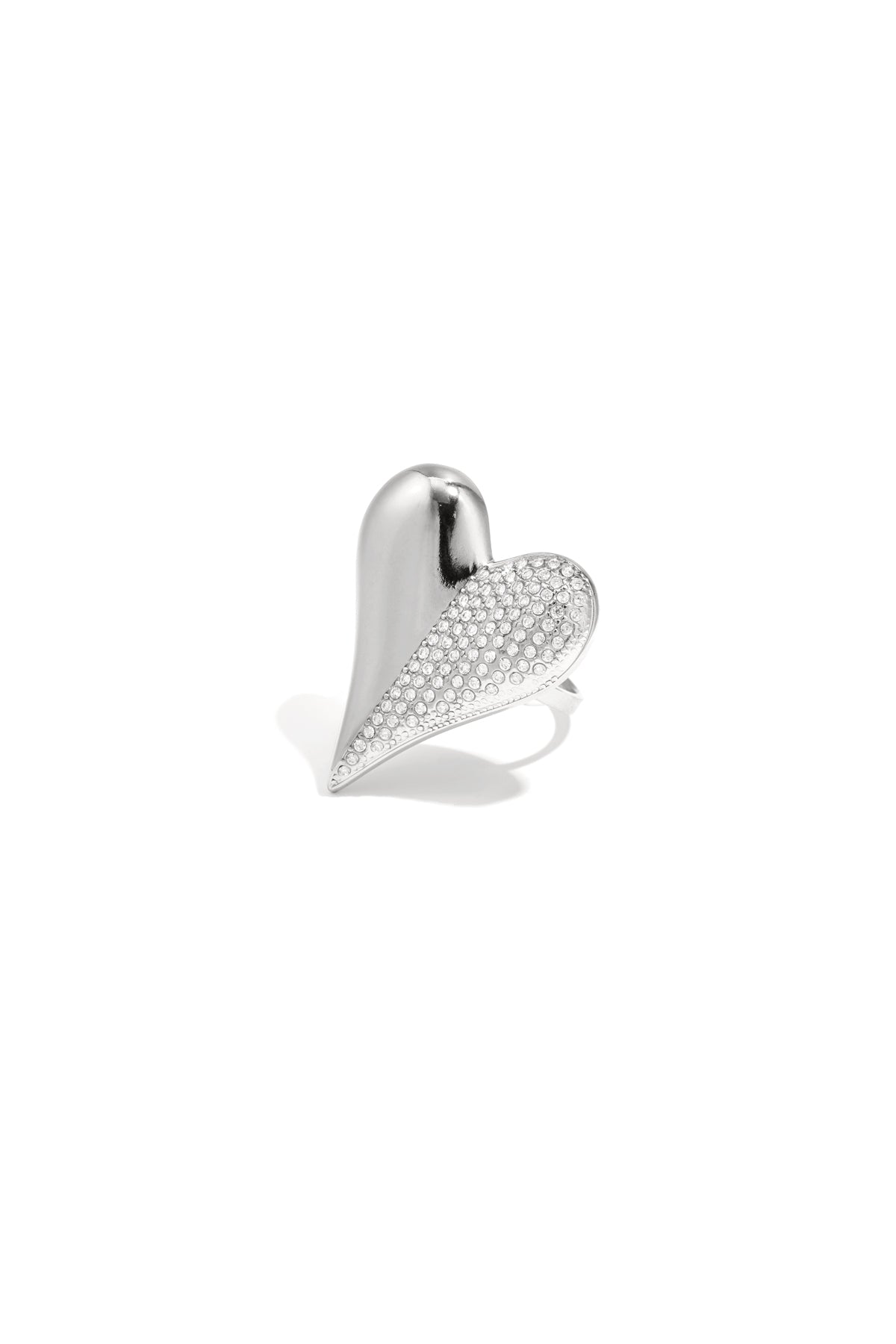 Silver-toned heart-shaped statement ring with rhinestones on one half against a white background