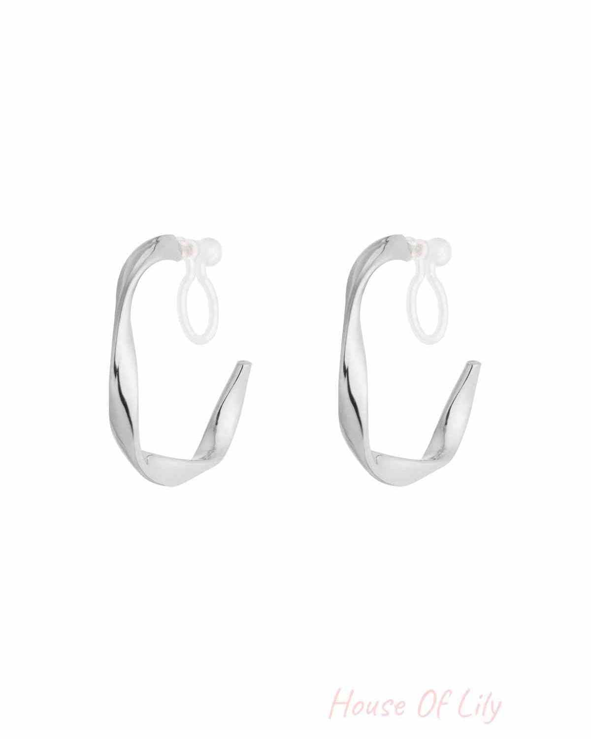 Pair of silver twisted hoop clip earrings with clear silicone backings