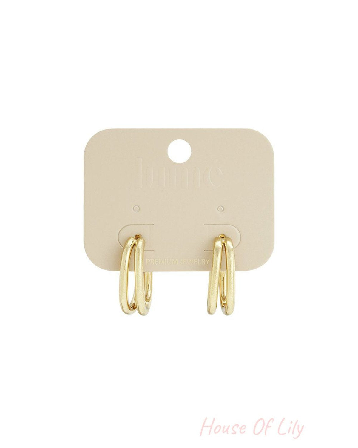 Main Character Energy gold-toned double-layered oval hoop earrings on a branded display card.
