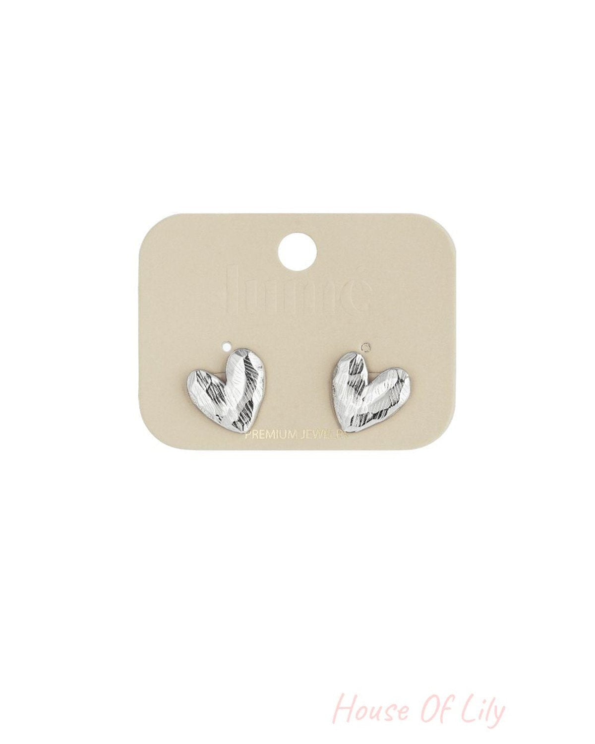Silver Puffy Heart Hype stud earrings featuring a textured, metallic finish on a display card.