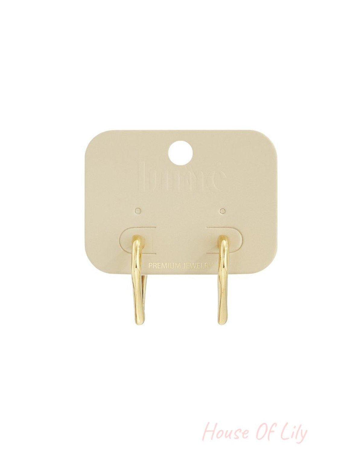 Dainty Heart Core Hoops: Small, gold-toned hoop earrings with a subtle, irregular heart-shaped design on a display card.