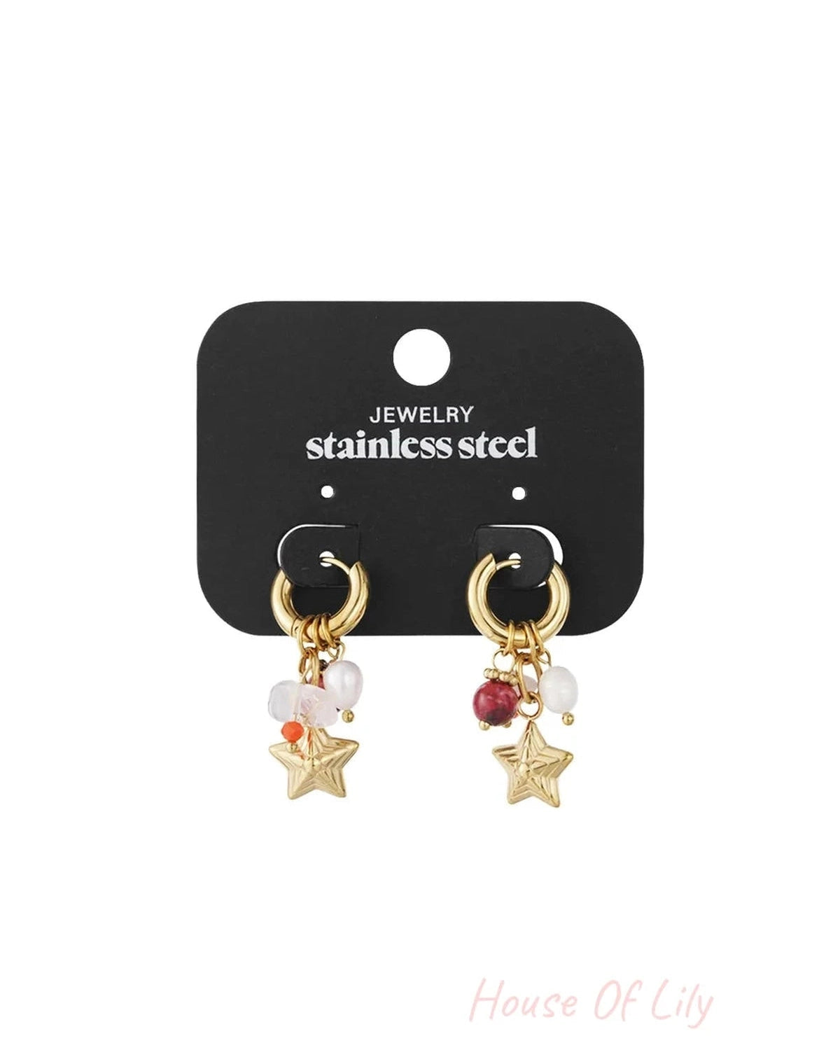 Gold stainless steel hoop earrings with charms including stars, white pearls, and red beads on a black display card.