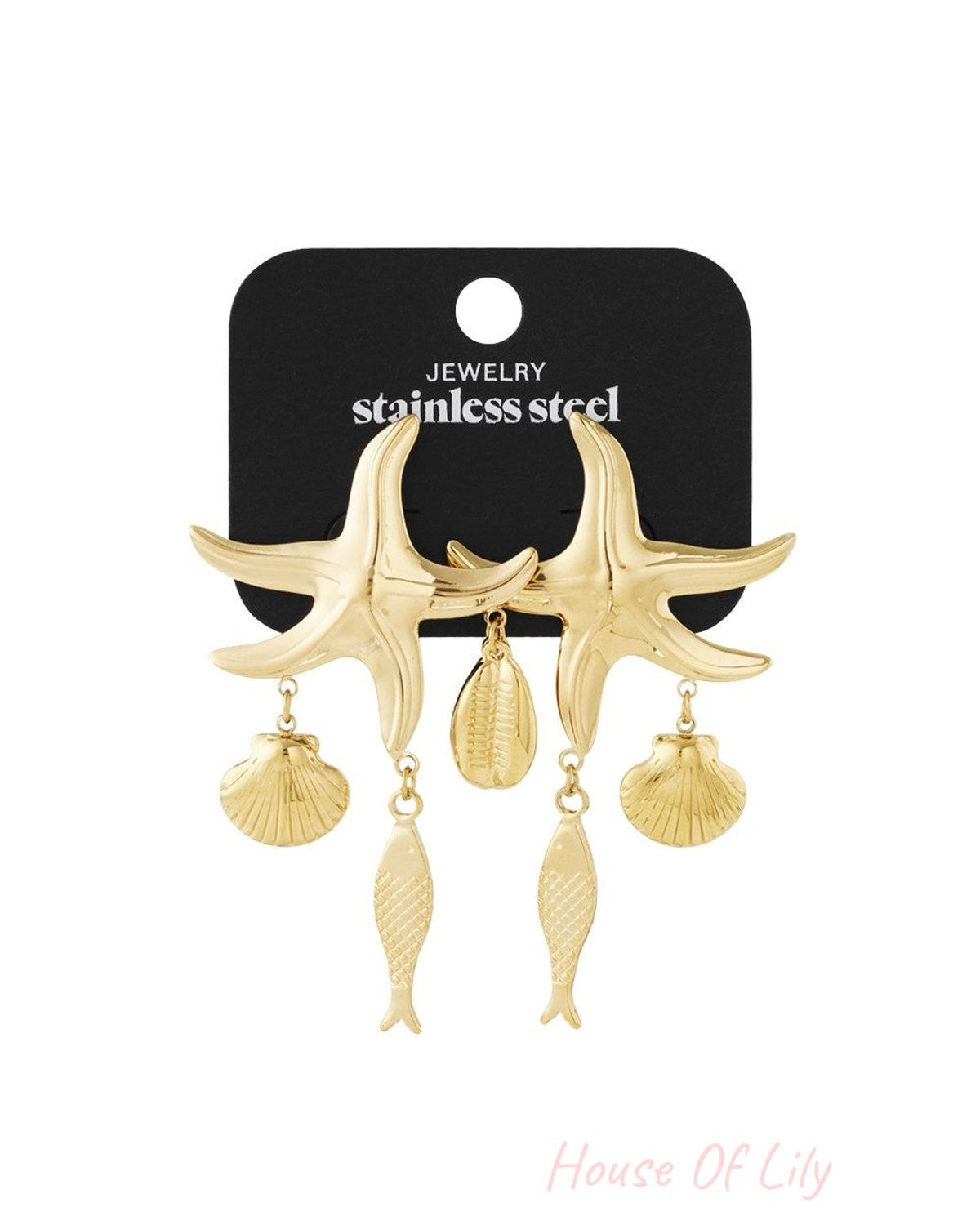 Gold-toned stainless steel starfish dangle earrings featuring hanging seashell and fish charms on a black display card.