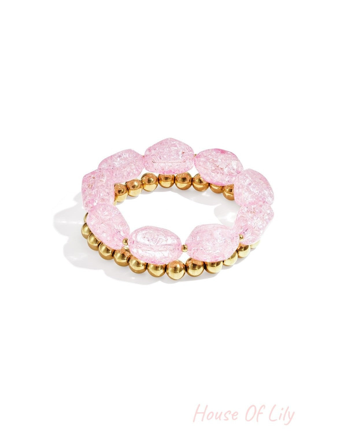 Light pink chunky beaded bracelet set with glossy acrylic and gold-tone metal beads displayed on white background