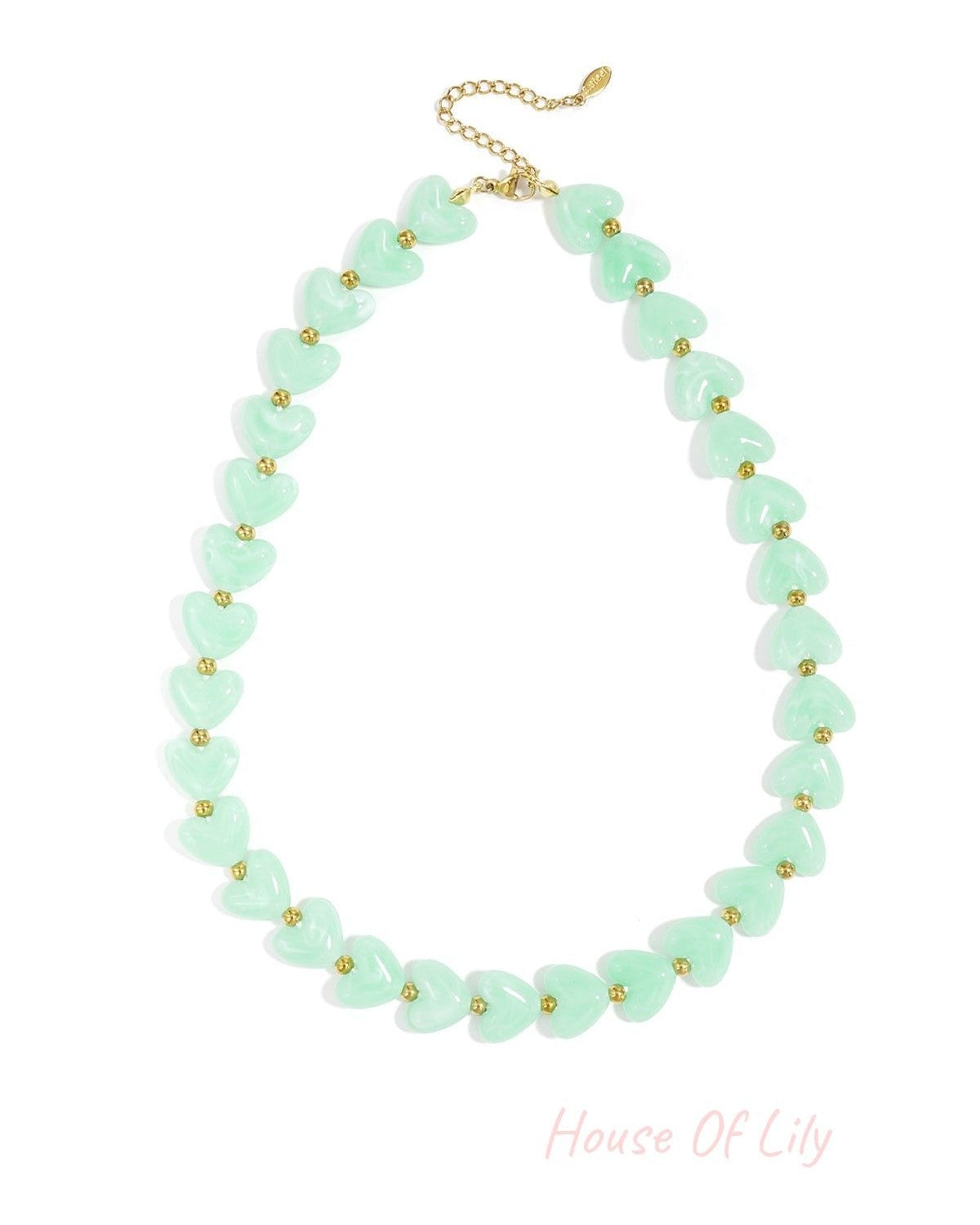 Mint green heart-shaped resin beads accented with small gold spacers on a gold chain necklace.