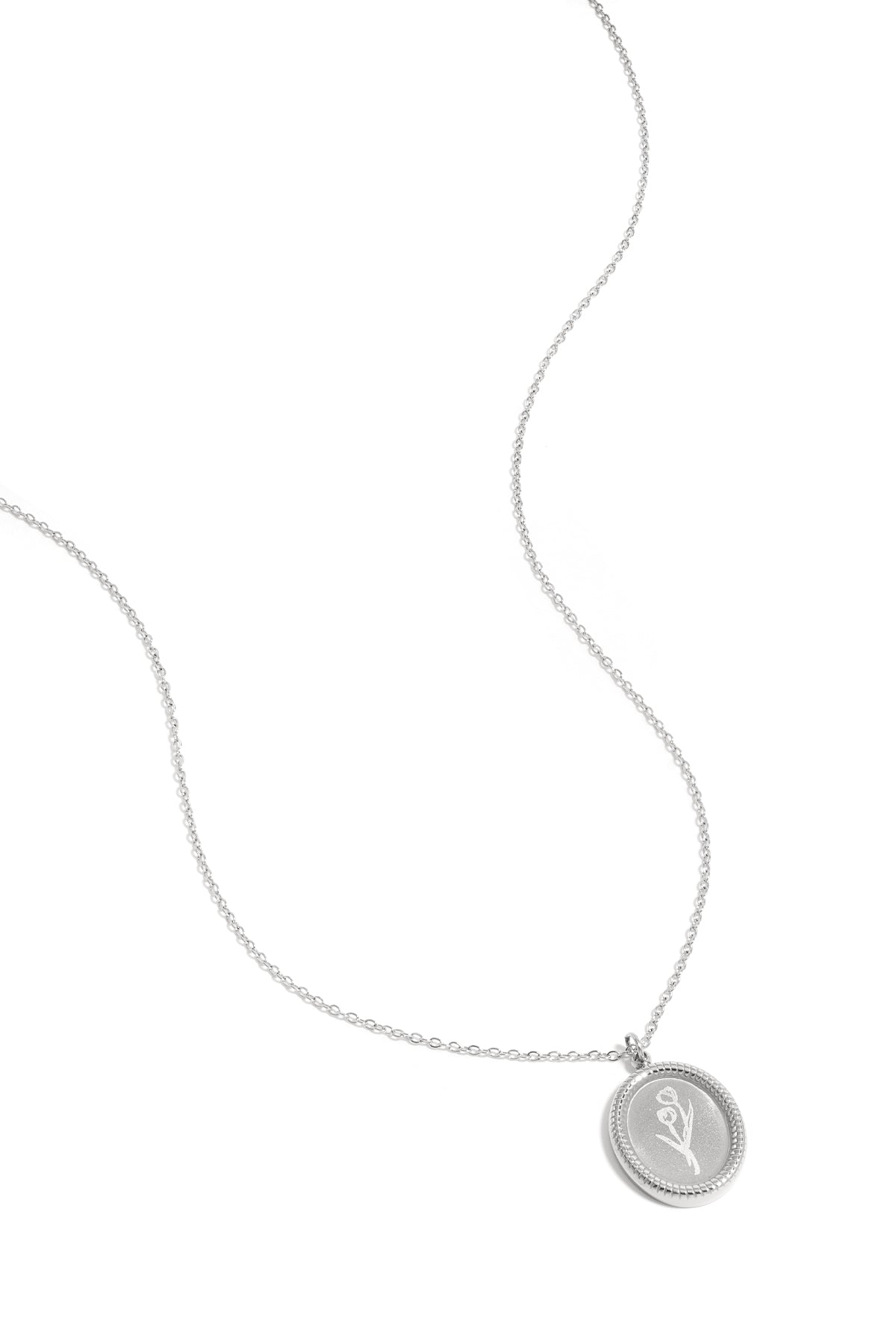 Close-up of silver tulip blossom pendant necklace on white background