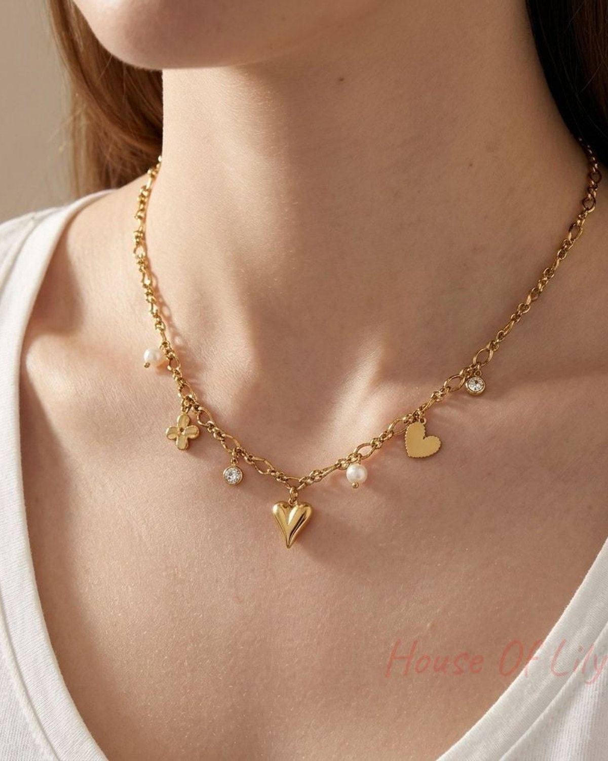 Close-up of a Dazzling Heart Charm necklace with rhinestones and imitation pearl on textured velvet, highlighting its sparkle and elegant design.