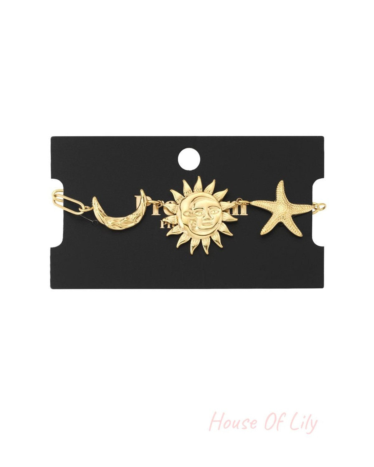Gold chain bracelet featuring celestial charms: a crescent moon, a face-engraved sun, and a textured starfish.