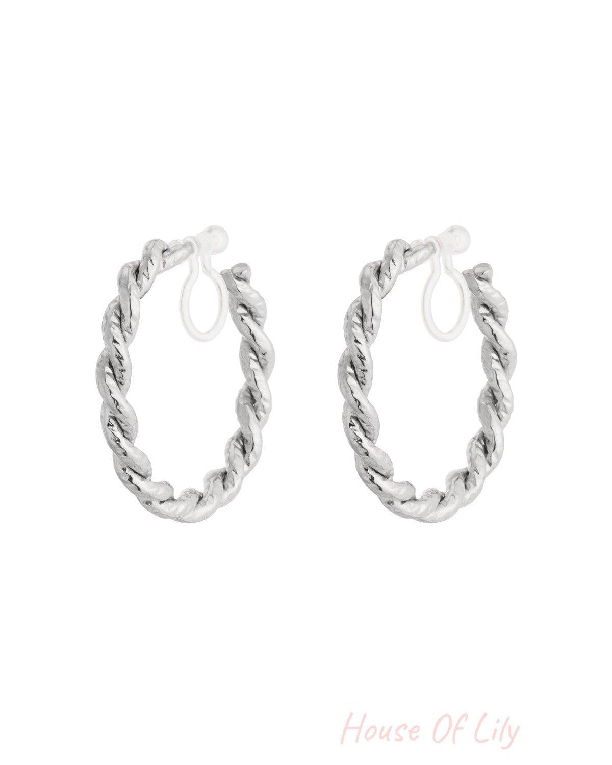 Silver-toned clip-on hoop earrings with twisted texture on white background