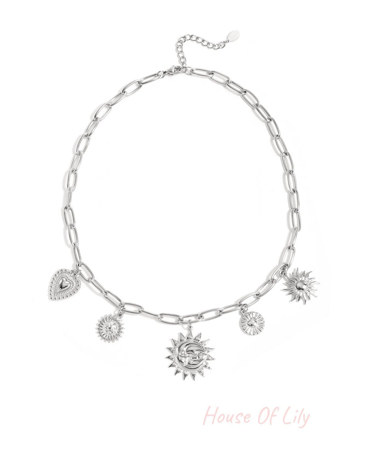 Silver-tone chunky chain necklace with sun and heart charms laid flat on white background