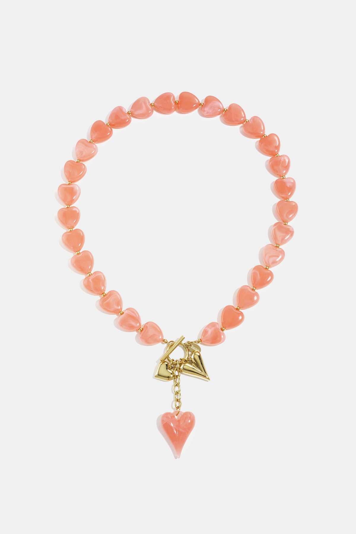 Amber brown heart bead necklace displayed on white background with gold charms and toggle clasp