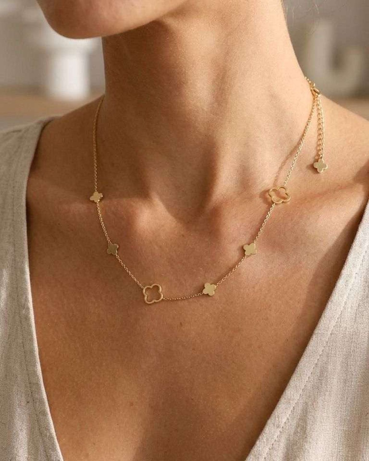 Close-up of the Lucky Clover Layering Chain on a female model showing stainless steel texture, small clover charm, and adjustable clasp.