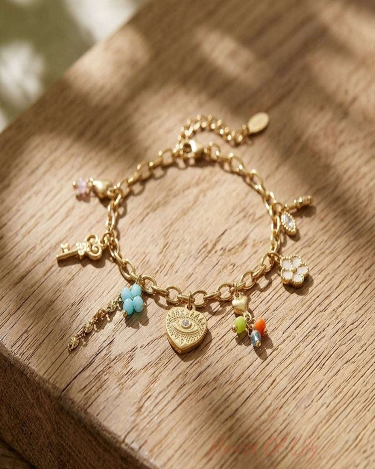Close-up of a tiny stainless steel secret love bracelet with a gold hue on a wooden surface, highlighting micro-texture and fine details.