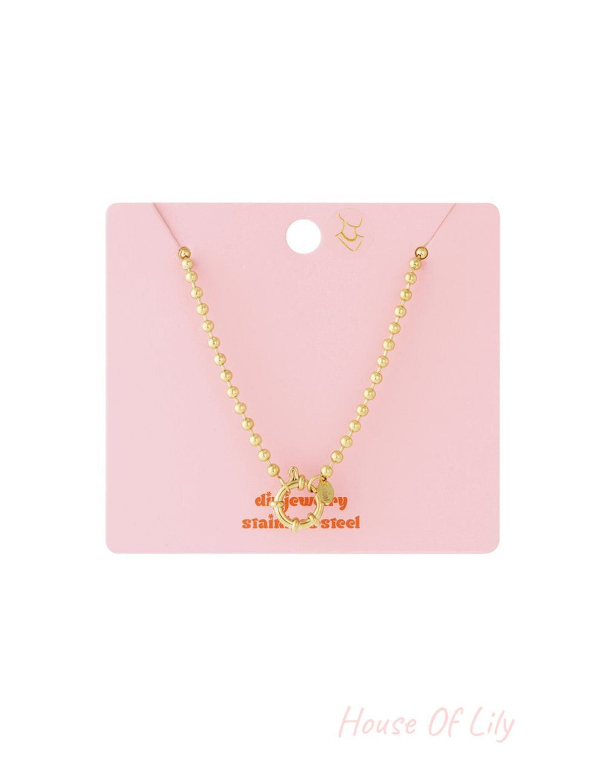 Gold beaded chain necklace with a front-facing circular spring clasp on a pink display card.