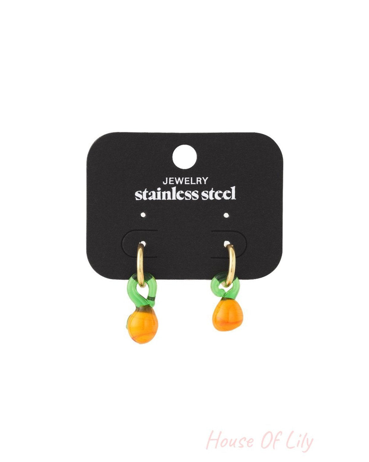 Citrus drop earrings featuring small gold hoops with green leaf and orange fruit glass charms on a display card.