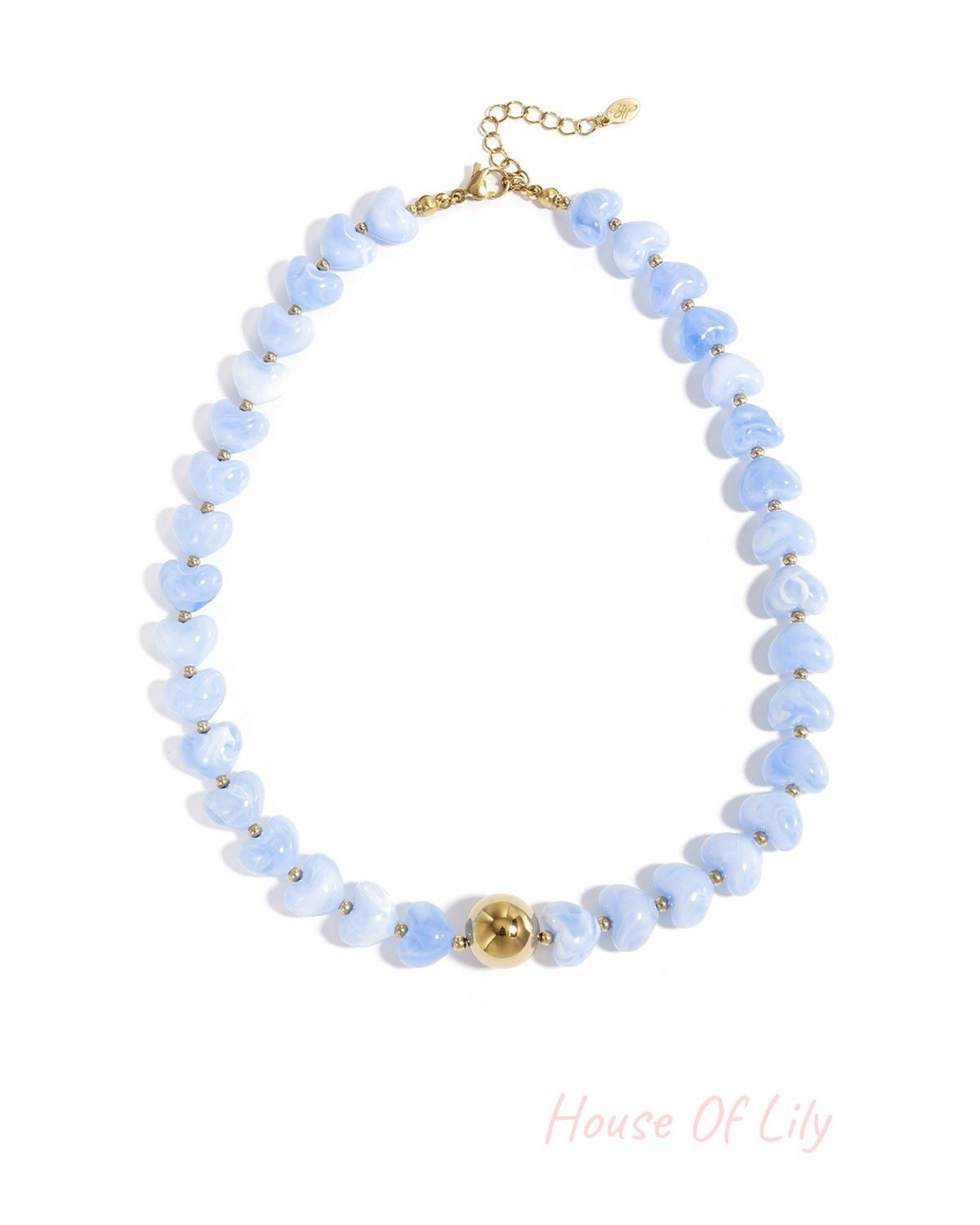Close-up image of a blue variant of the heart-shaped beaded necklace with gold round bead and adjustable clasp on white background