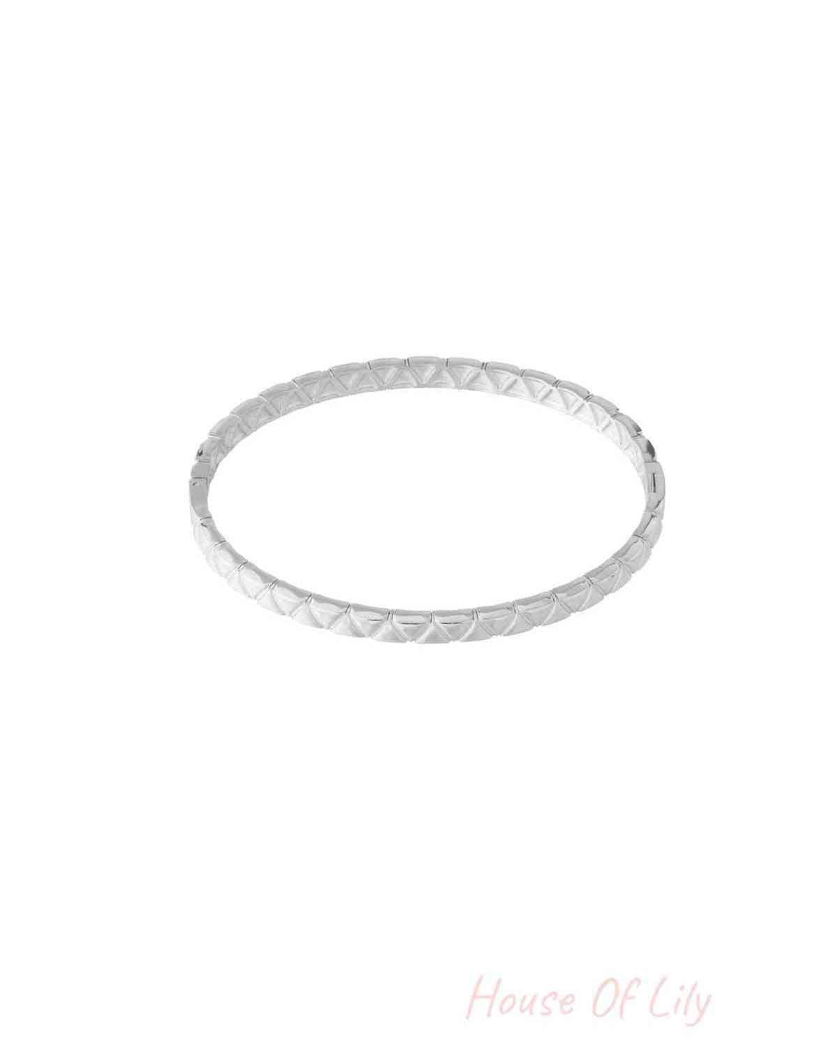 Silver textured bangle with geometric pattern isolated on white background