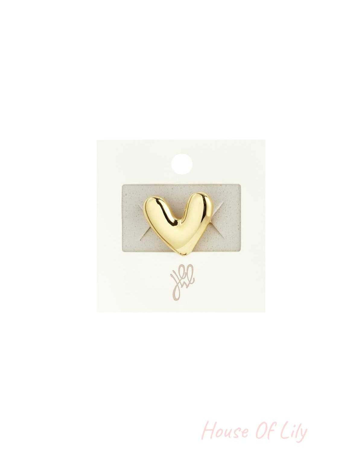 Gold chubby heart-shaped statement ring displayed on branded jewelry card packaging