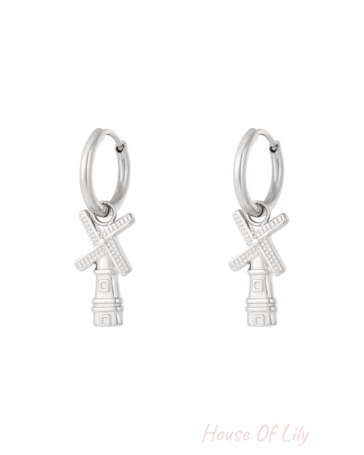 Pair of silver windmill charm hoop earrings with detailed blades on white background