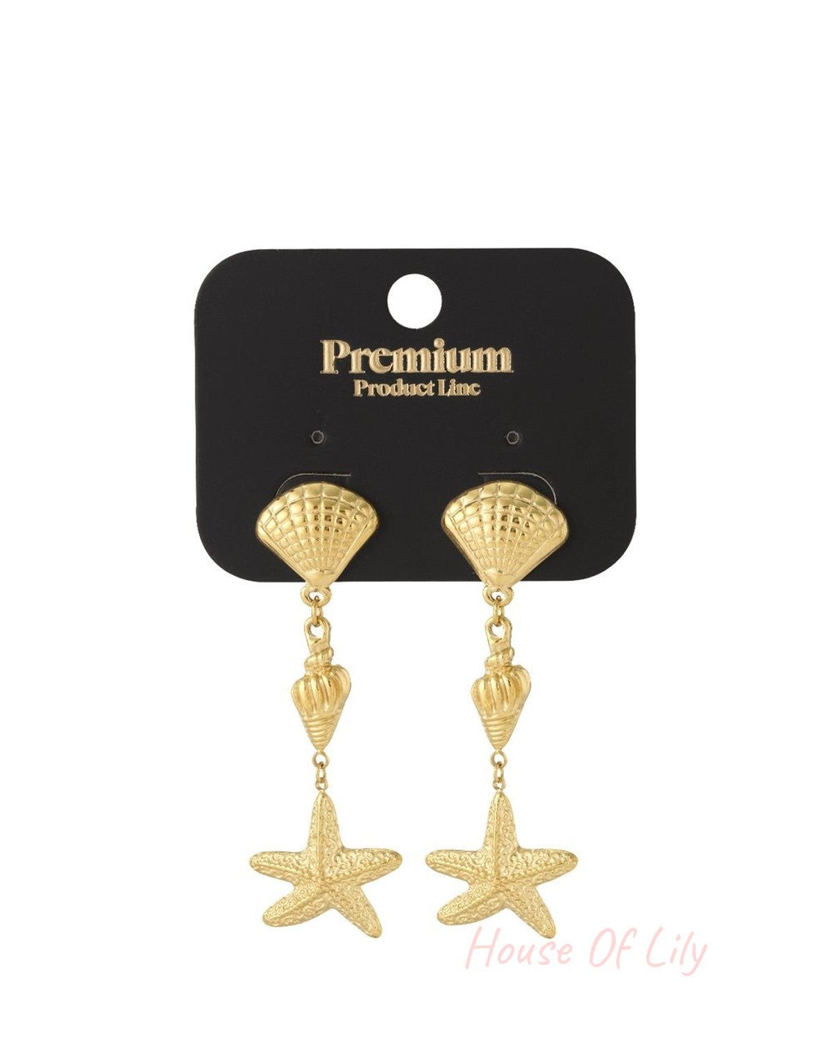 Gold-toned coastal dangle earrings featuring a fan shell, spiral shell, and starfish charm on a black display card.
