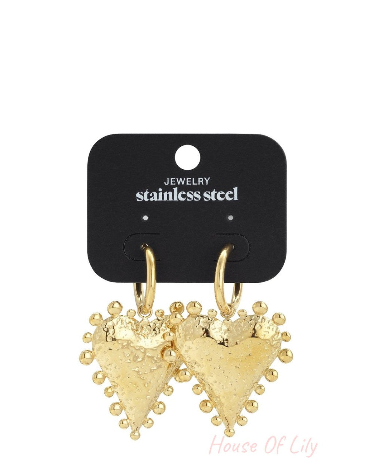 Gold stainless steel hoop earrings with textured, studded heart charms on a black display card.