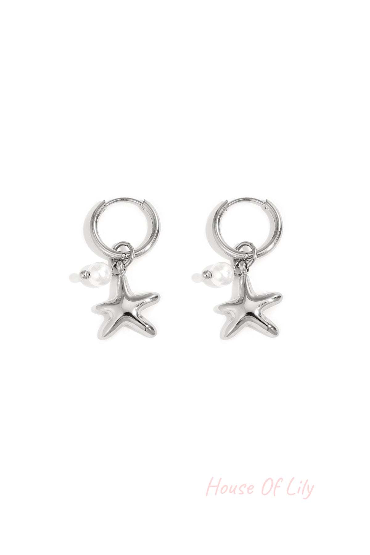 Pair of silver starfish charm hoop earrings with small pearl detail on white background