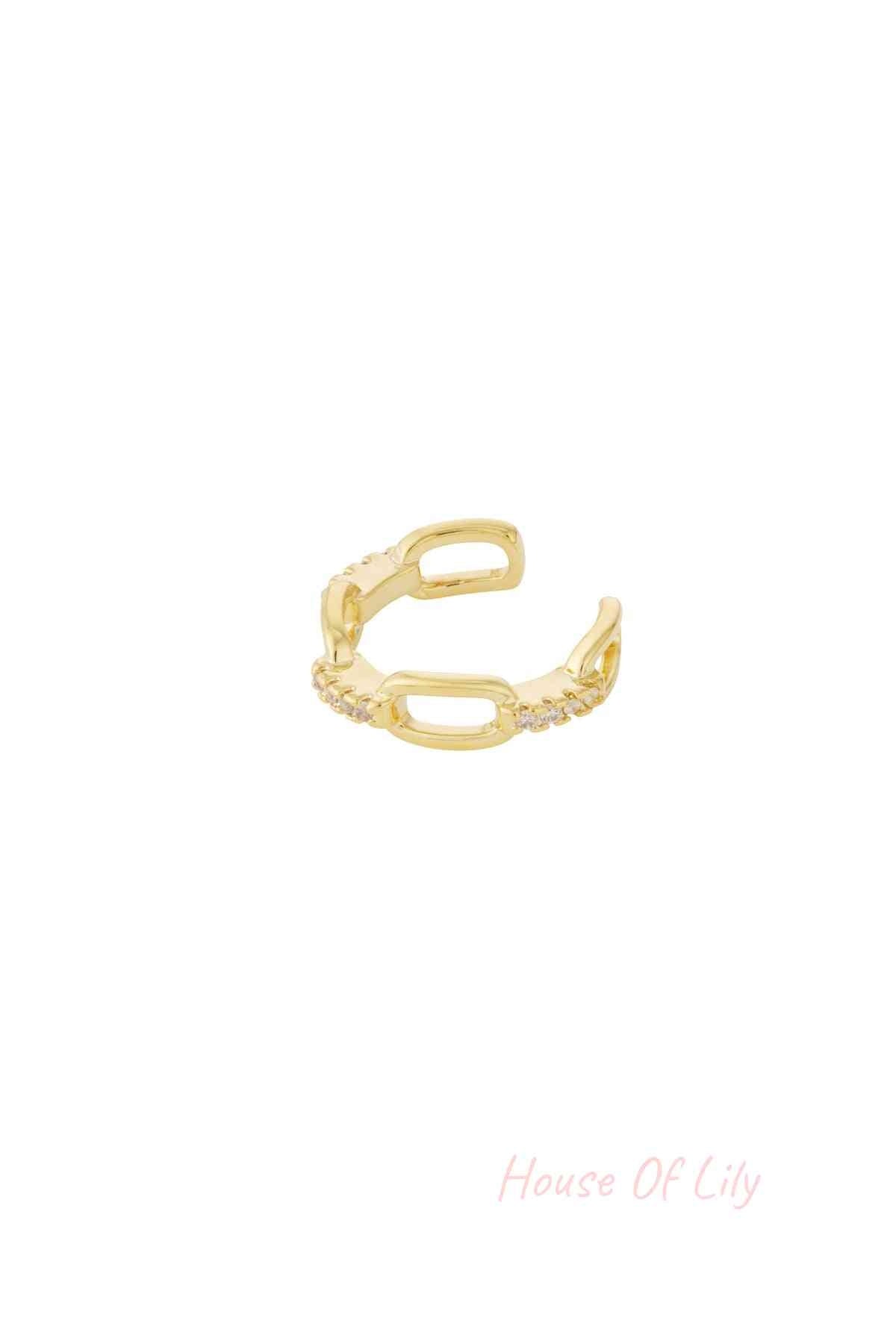 Gold chain link ear cuff with cubic zirconia on white background