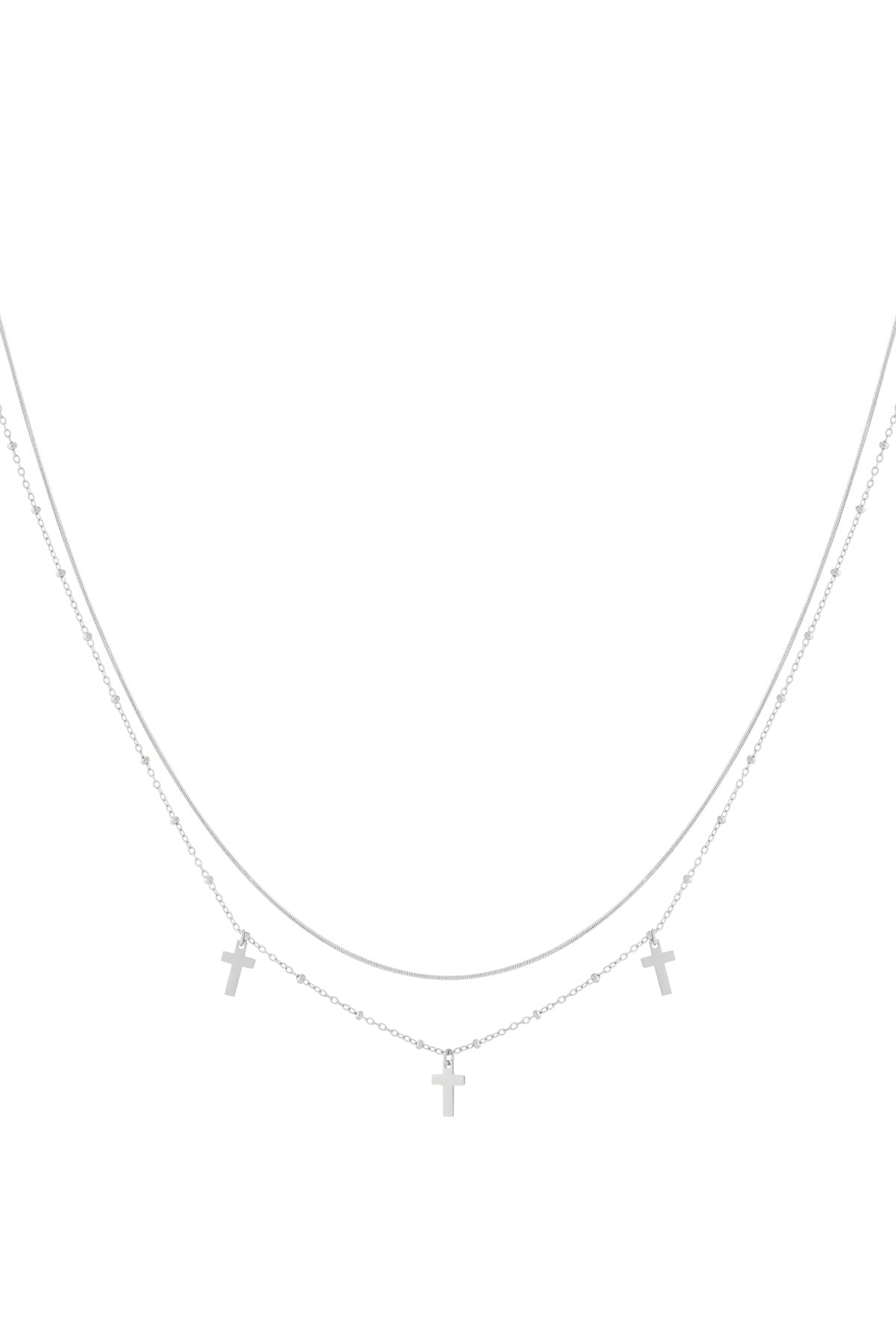 Silver layered necklace with two fine chains and three small cross pendants displayed on a white background