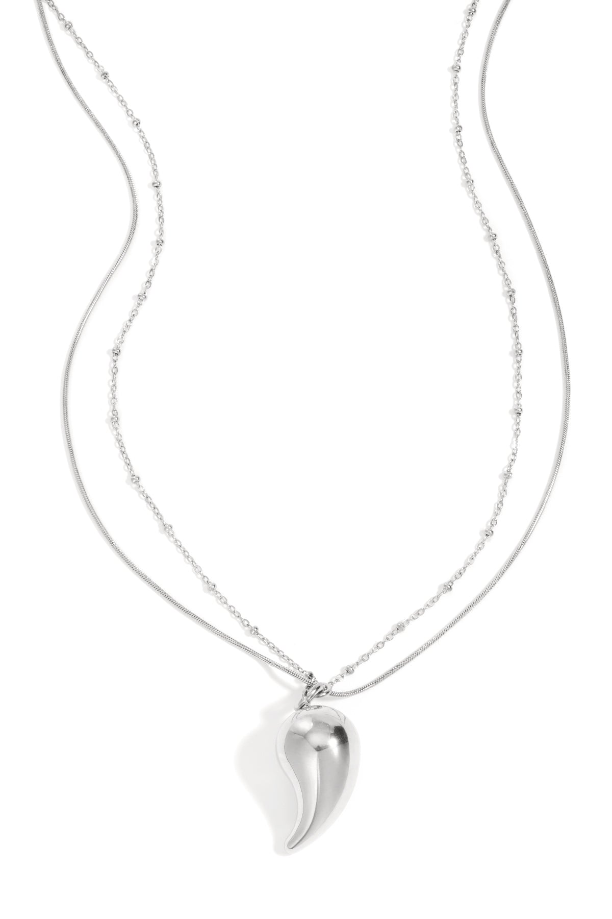 Silver layered necklace with a curved droplet pendant on a white background featuring delicate mixed chains