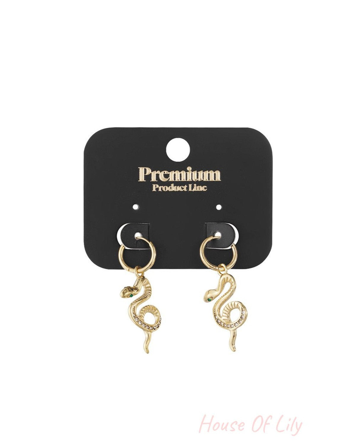 Gold hoop earrings featuring dangling snake charms with crystal-accented bodies and green stone eyes on a black card.